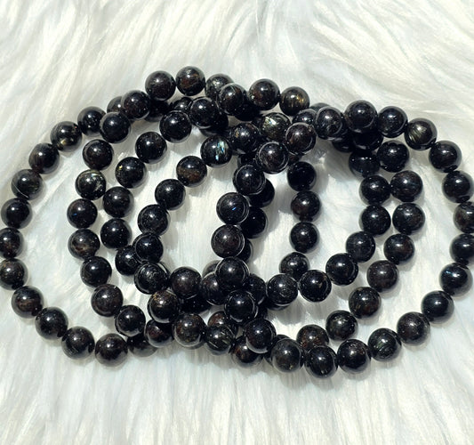 Astrophyllite- endocrine and reproductive support, align chakras, grounding, astral travel, transformation