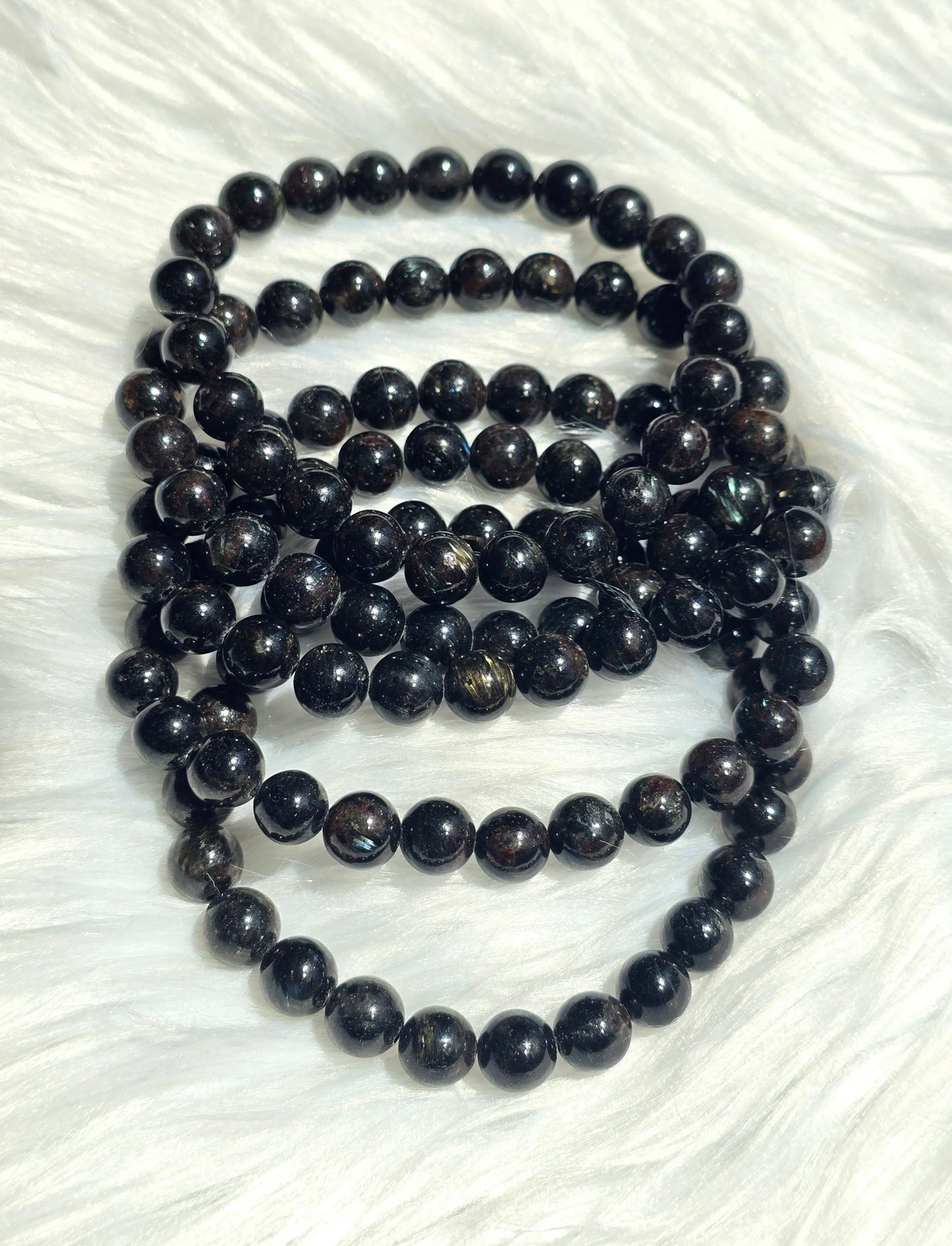 Astrophyllite- endocrine and reproductive support, align chakras, grounding, astral travel, transformation